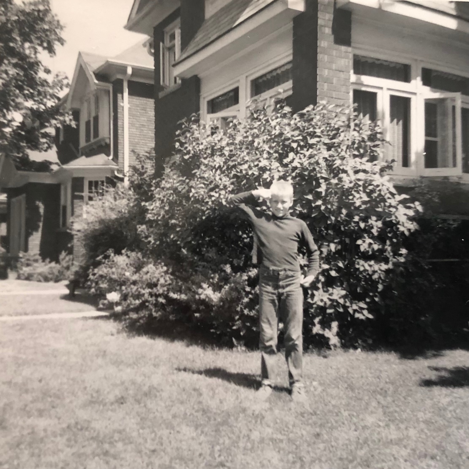 One of Lois Broad's five boys salutes outside the house at 31 Glendonwynne.