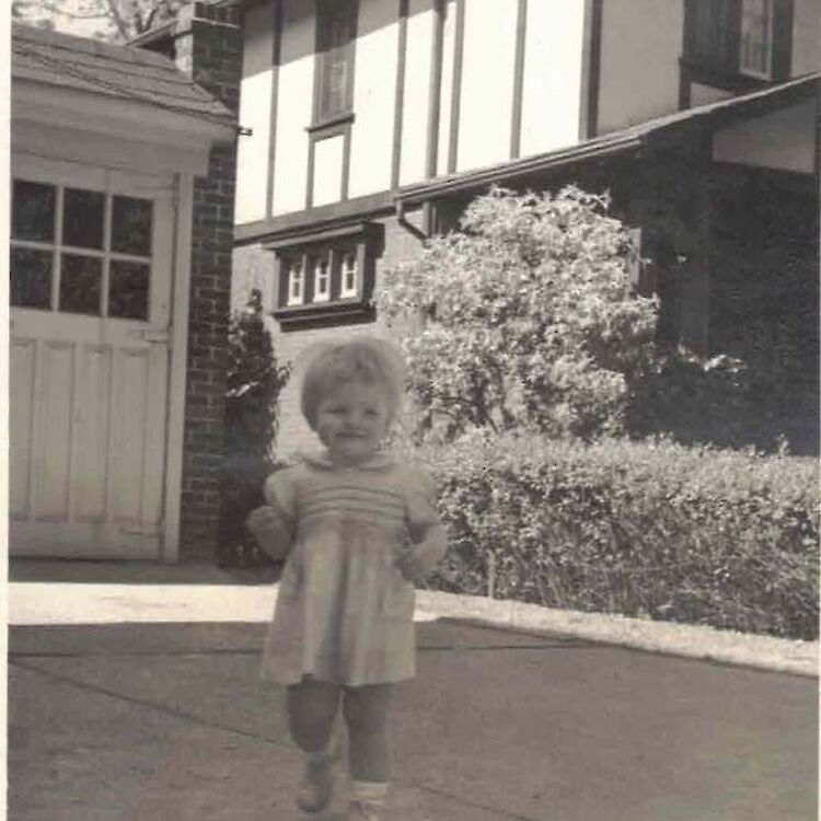Bruce McDougall's sister in front of a home on Indian Rd. (Photo courtesy of the family.