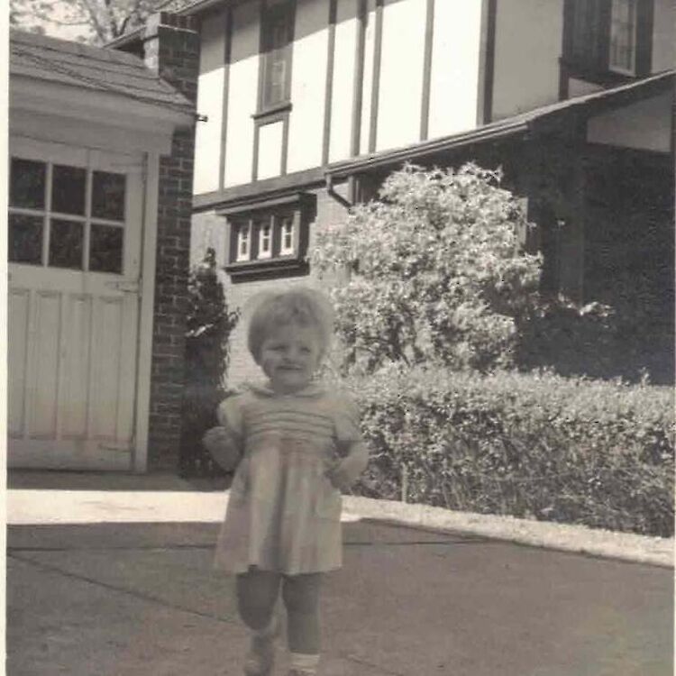 Bruce McDougall's sister in front of a home on Indian Rd. (Photo courtesy of the family.)